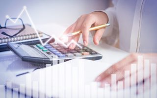Accountant calculating profit with financial analysis graphs